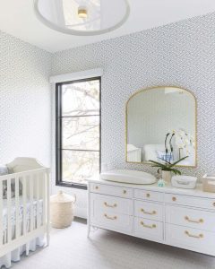 blue-nursery-wallpaper-with-white-crib-and-dresser-vogeinteriors