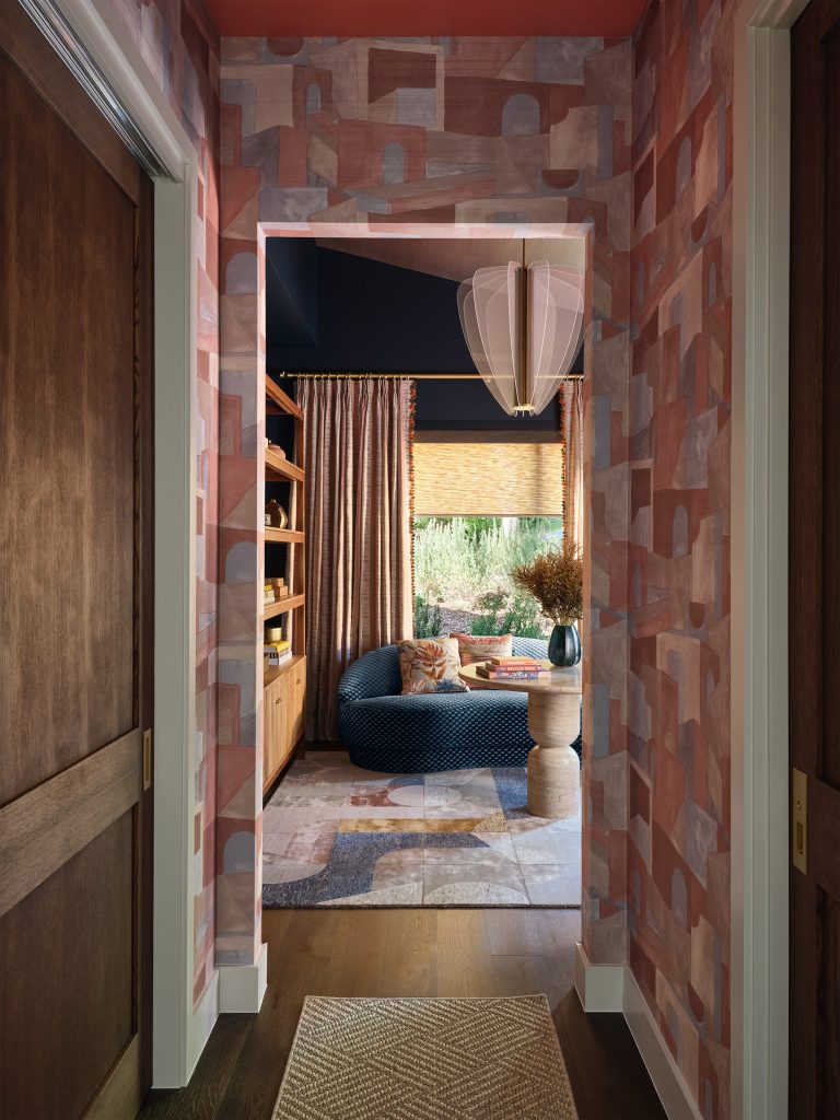 Phillip Jeffries "Villa Vibes" wallpaper leading into secondary living area designed by Amber Guyton